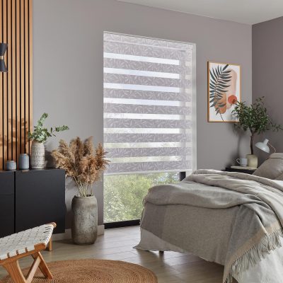 White patterned dual-layer vision roller blind in bedroom with grey and cream décor